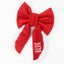 A red bow with the word &quot;BLUE&quot; written on it.