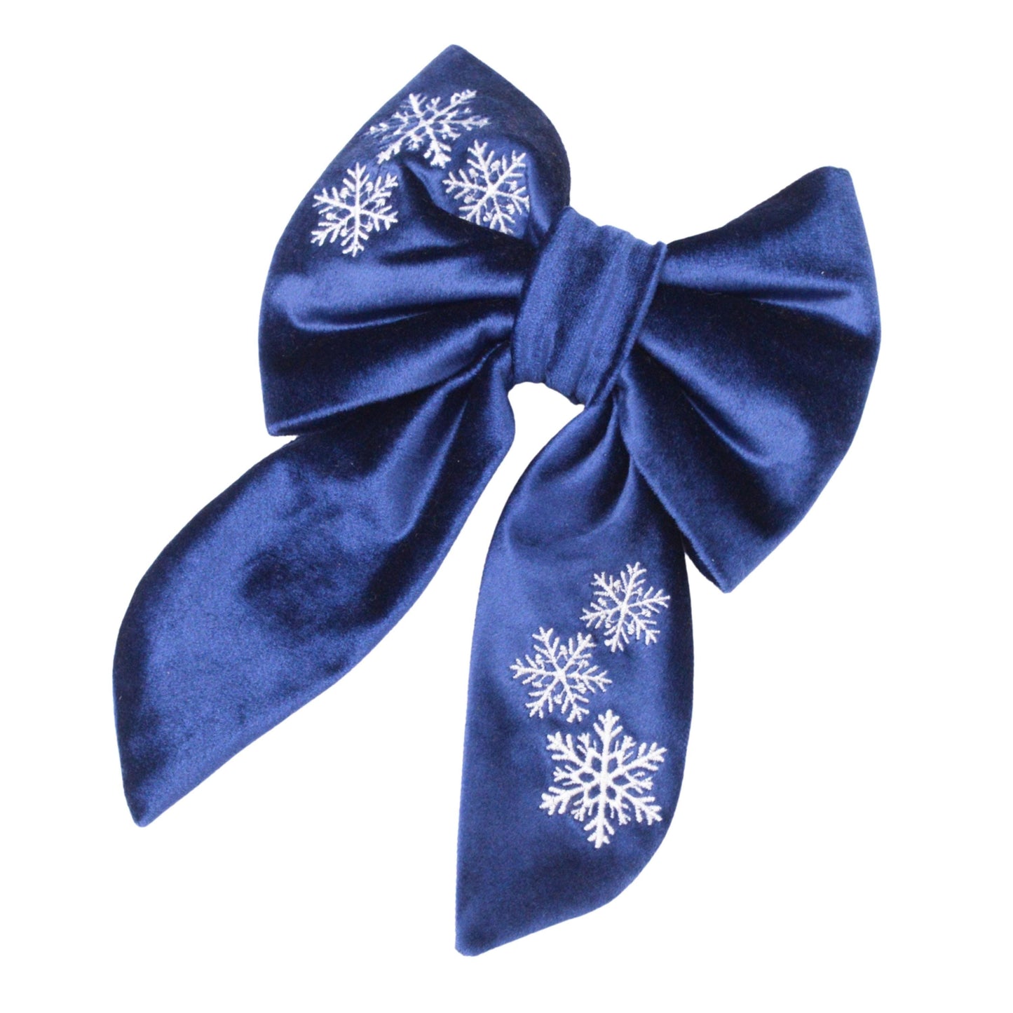 A blue satin bow with white snowflake designs on it.