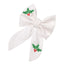 A white bow with green holly leaves and red berries embroidered on it.