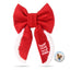 A red bow with white trim, featuring the word &quot;BLUE&quot; written on it.
