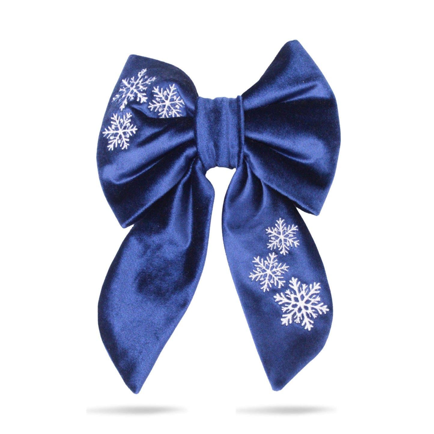 A blue satin bow with white snowflake designs on it.
