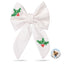 A white bow with red berries and green holly leaves, featuring a small logo in the bottom right corner.